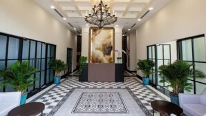 A lobby with a checkered floor, a central reception desk, and potted plants. - CityHouse - Atelier Thao Dien (Ho Chi Minh City)