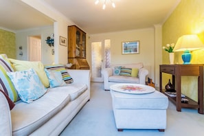 A living room with a sofa, ottoman, and a cabinet. - Toast Stays - Elgin Escape (Darlington)
