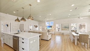 A spacious kitchen with a central island, white cabinetry, and pendant lighting. - No Agenda Hacienda QUARTER MILE WALK TO BEACH (Port Aransas)