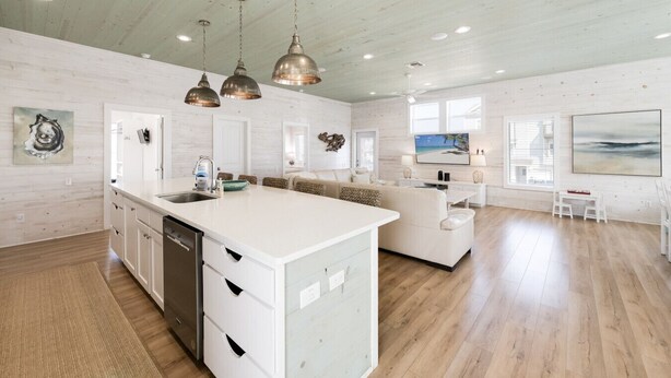 A spacious kitchen with a central island, white cabinetry, and pendant lighting. - No Agenda Hacienda QUARTER MILE WALK TO BEACH (Port Aransas)