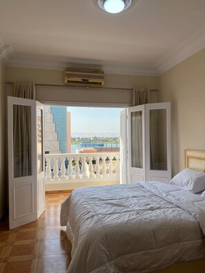 Tabla de planchar con plancha, internet y ropa de cama