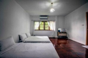 A room with two beds, a desk, and a window with curtains. - DoubleTree House (Chiang Mai)