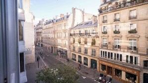 A street view with historic buildings, a storefront named 'Maison de la Porcelaine', and a clear sky. - Modern accommodation, near Parisian attractions (Paris)
