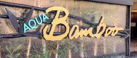 A sign with the words "AQUA Bamboo" in stylized font, with bamboo elements integrated into the design.