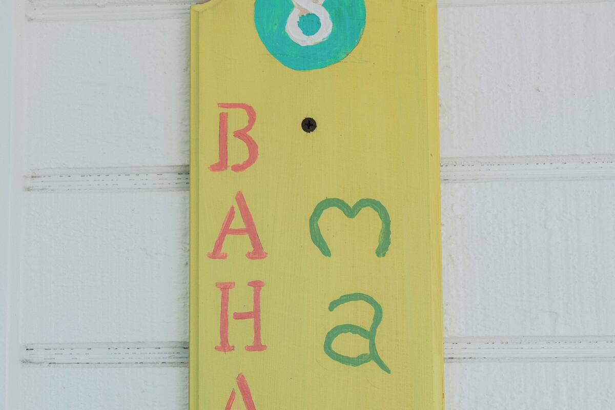 A yellow sign with the number 8 and the name "BAHAMAS" written vertically.