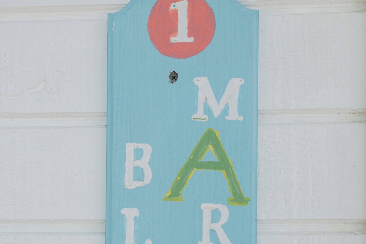 A blue sign with white letters spelling "MARLIN BLUE" and a red circle with the number "1" above it.