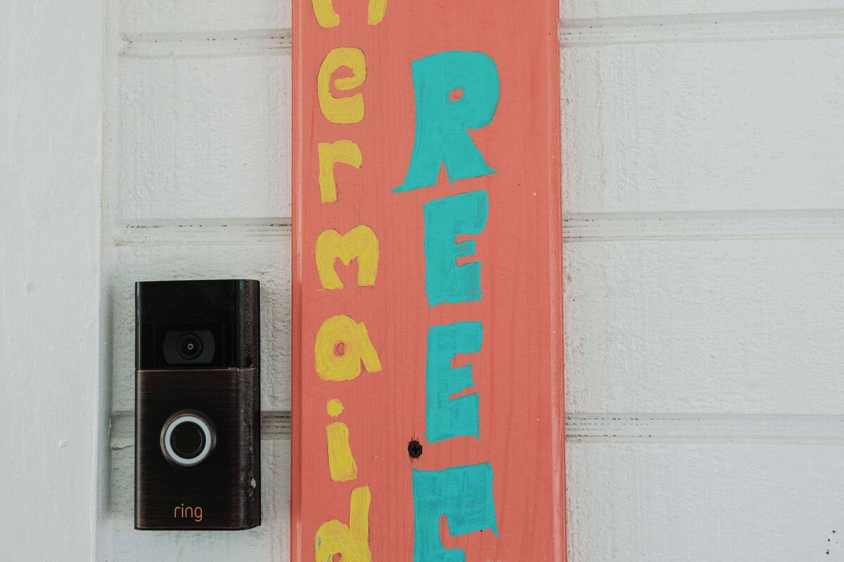 A doorbell with a nameplate above it.