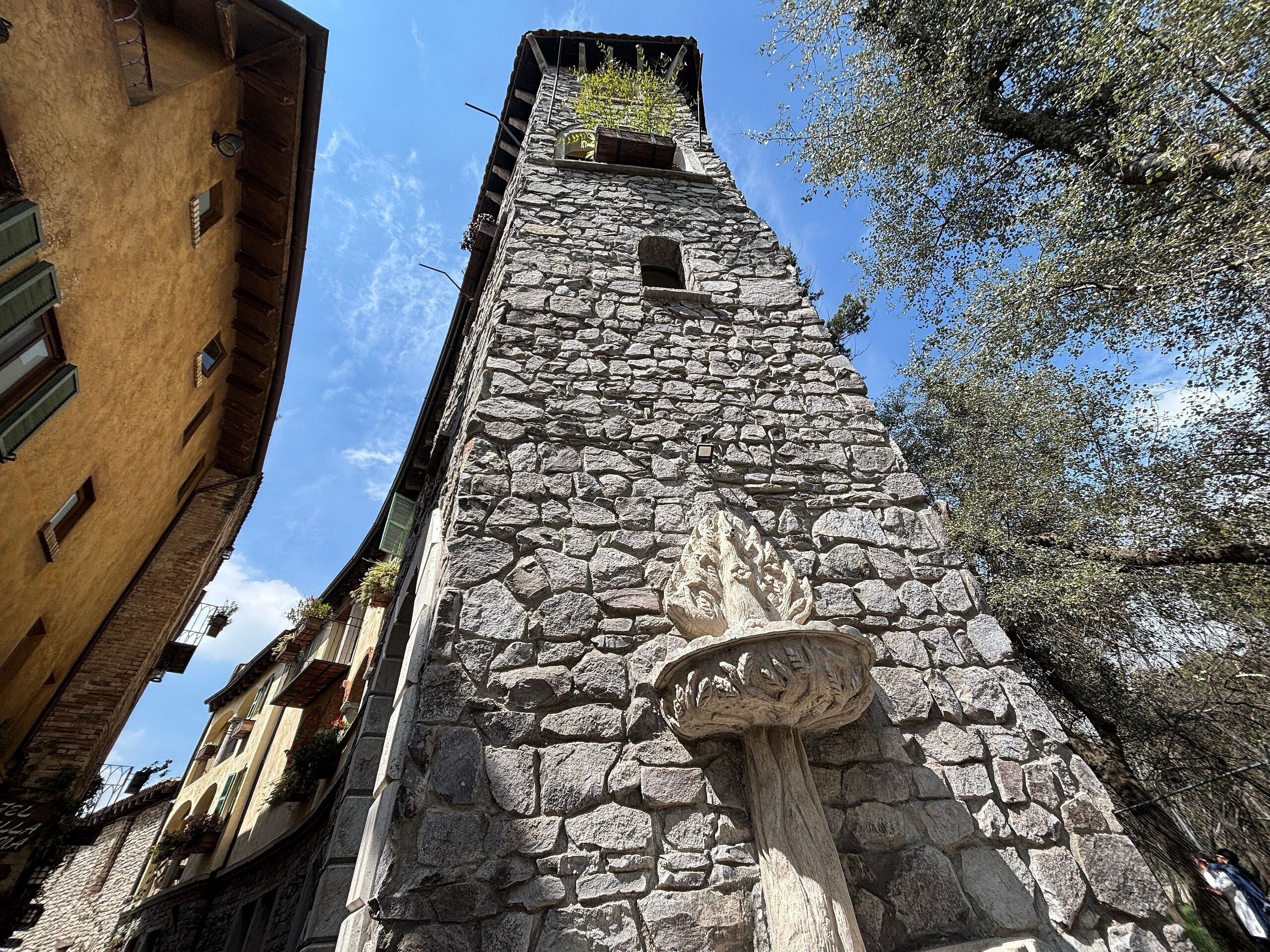 A stone tower with a narrow staircase leading to a small window.