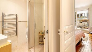 A bathroom with a glass shower door, a towel rack, and a sink. - Lovely stay close to the Eiffel Tower (Paris)