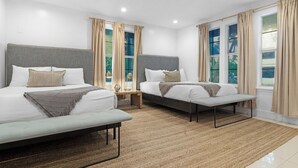 A modern hotel room with two beds, a bench, a small table, and large windows with curtains. - 7BD Downtown Oasis Pool  (Miami)
