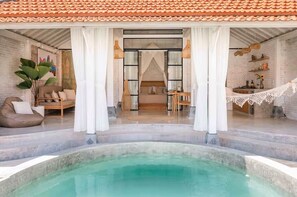 A luxurious spa area with a pool, a cozy seating area, and a bedroom with a view of the pool. - Private Pool Villa in Bisma, Ubud Super-walkable (Ubud, Kecamatan Ubud, Kabupaten Gianyar)
