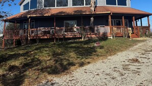 A large, two-story house with a prominent front porch and multiple windows. - DERBY SPECIAL  includes parking spot 50 ft from the track . 6-bedroom lodge (Bloomfield)