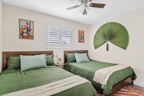 A bedroom with two beds, a ceiling fan, a window with blinds, and a wall-mounted fan. - Stylish 4BR Scottsdale Retreat | Pool + Hot Tub | Sleeps 11 (Scottsdale)