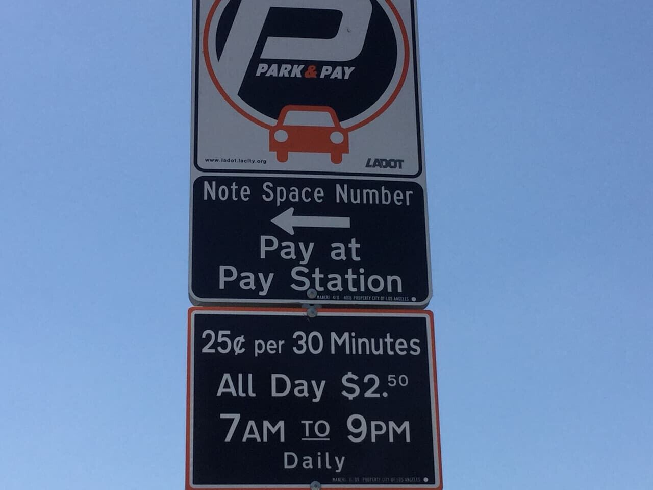 A parking sign with a space number and payment instructions.