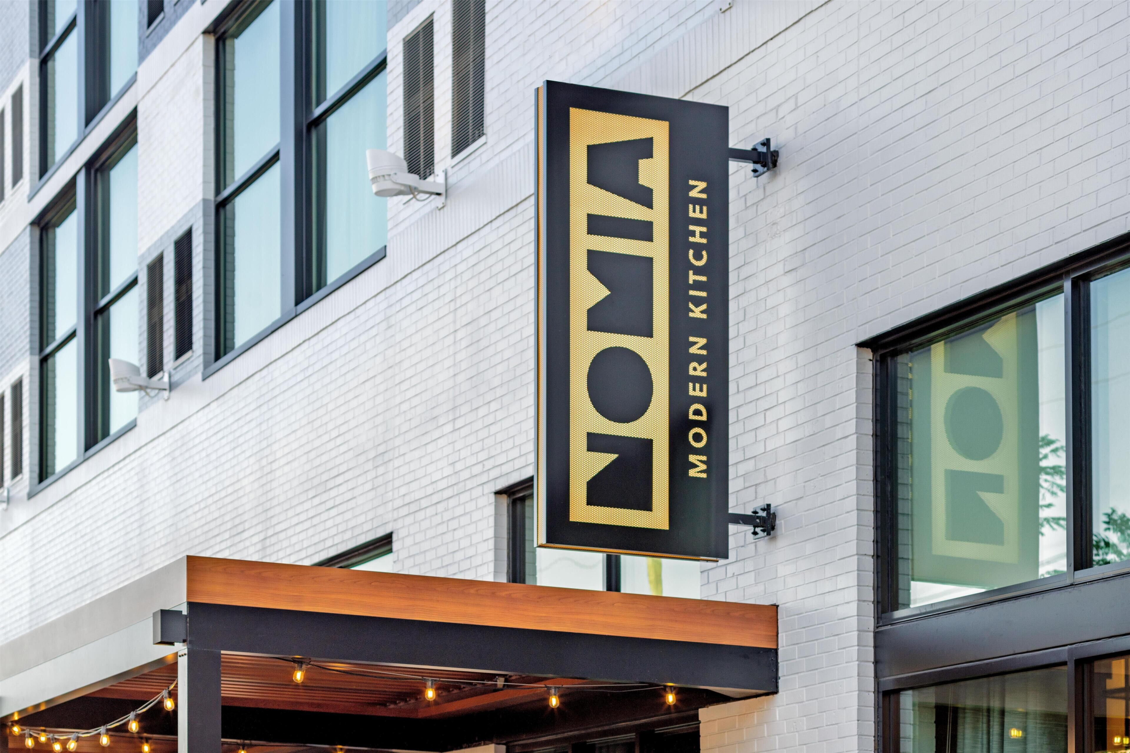 A building with a sign that reads 'NOMIA MODERN KITCHEN.'