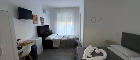 Deluxe Quadruple Room, Balcony, Park View | Desk, laptop workspace, free WiFi