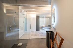 A modern bathroom with a glass shower enclosure, a round mirror, and a wooden frame. - Attico Salia - La Maddalena (La maddalena)