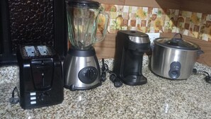 A kitchen with a blender, coffee maker, and electric kettle on a granite countertop. - Nice and Comfortable Apartment on second floor#202 (Dosquebradas)