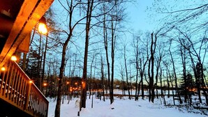 A snow-covered path with a wooden bridge and bare trees. - Lake Monster Family Adventure! Kayak fishing Firepit Hot tub Sauna Games & More (Tobyhanna)
