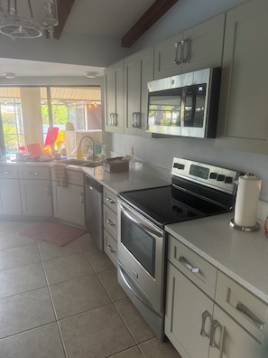 A modern kitchen with stainless steel appliances, a microwave, and a stove.