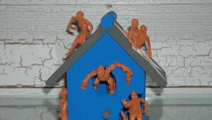 A toy house with figures on top and a figure standing in front. - Charming 1-bedroom barn in Austin (Austin)