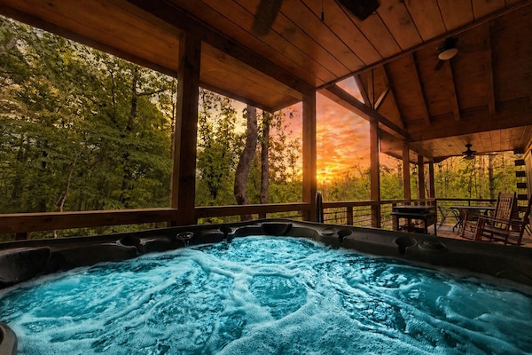 Soak in the hot tub overlooking the trees.