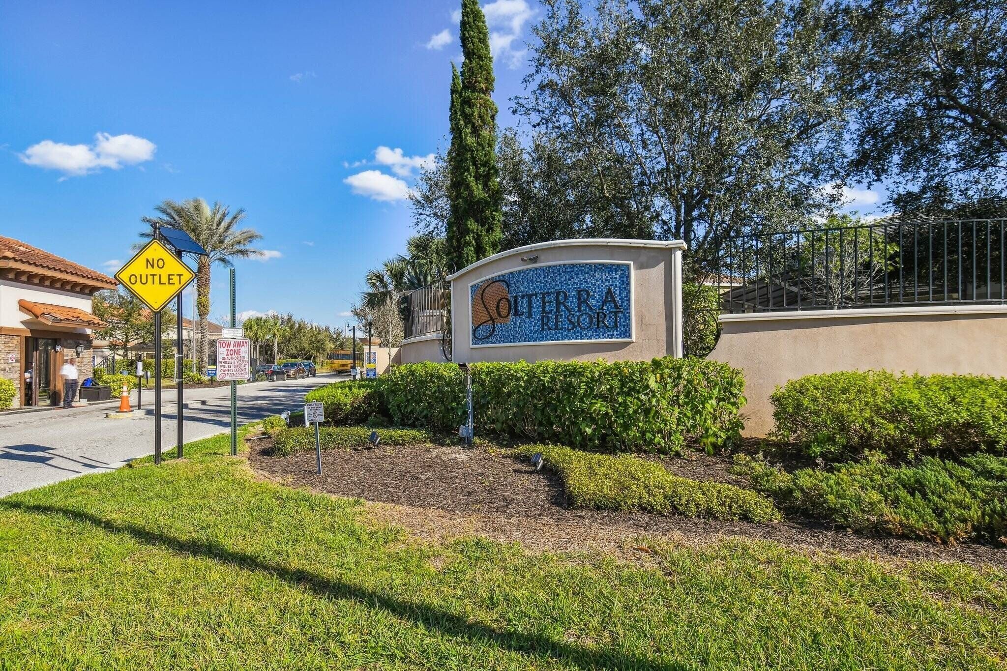 A sign for Soterra Resort with a 'No Outlet' sign and a 'Tow Away Zone' sign.