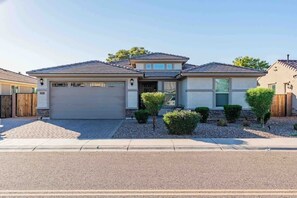 A single-story house with a garage, a front porch, and a small front yard with landscaping. - The One | Glendale | Pool & Spa | State Farm (Glendale)