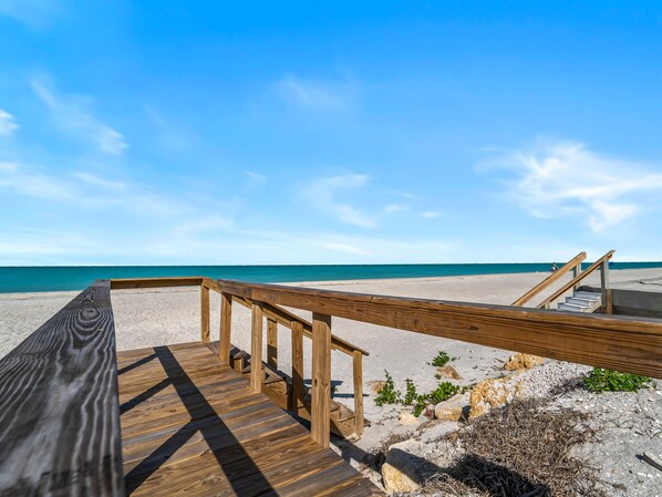 A wooden boardwalk leading to a beach with a clear sky. - Seahorse Cottage 2 - 2/2 with Private Beach (Englewood)