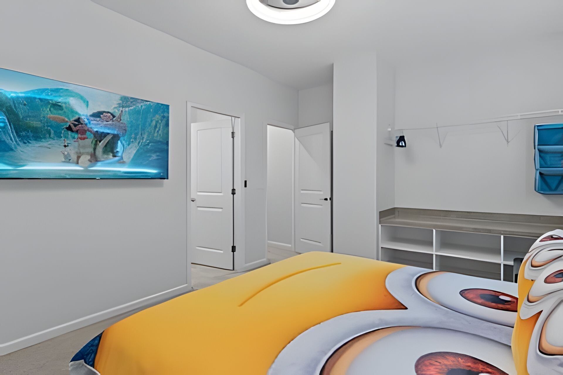 A bedroom with a bed, a door, a painting, and a dresser.