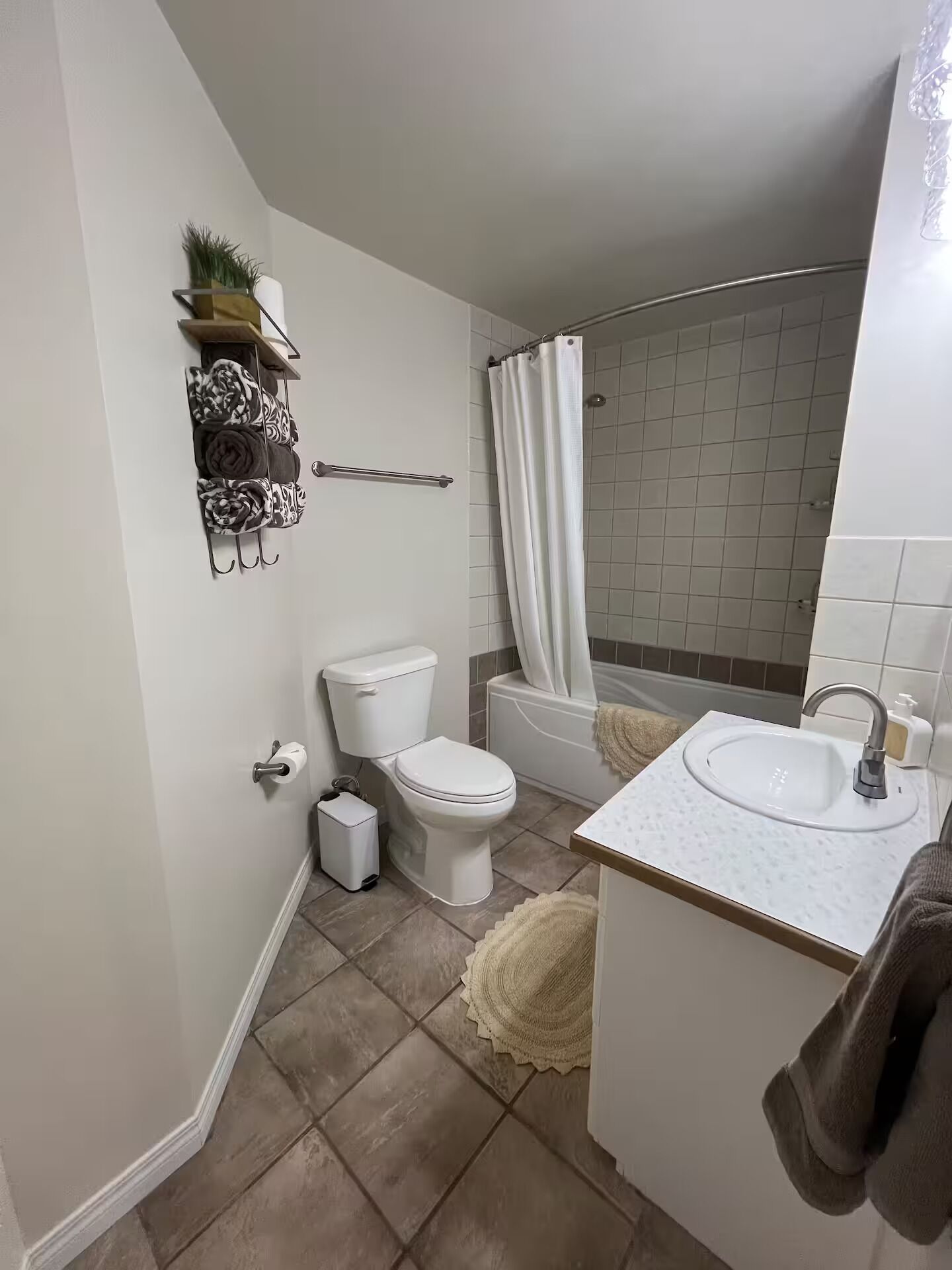 A modern bathroom with a toilet, sink, and shower.