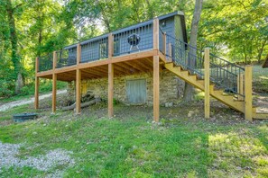 A rustic cabin with a wooden deck and a staircase leading to a second level. - Lakefront Home|Pet Friendly|Sleeps 20|Private Dock (Gravois Mills)