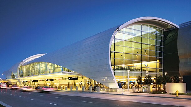 A modern airport terminal with a curved glass facade and a spacious interior. - Family and Business Friendly Home near Great Mall & BART - 2640 (San Jose)