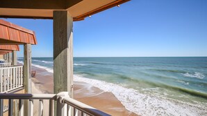 A beach view from a balcony with wooden railings and a wooden structure. - Coast is Clear– Oceanfront Escape at Topsail Dunes (North Topsail Beach)