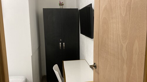 Budget room. 1 single bed, desk, TV, closet. Shared bathroom outside the room.