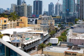 A cityscape with various buildings, including a hotel with a rooftop terrace and a view of the surrounding urban area. - Deluxe Two Bedroom Hilton Apartment (Surfers Paradise)