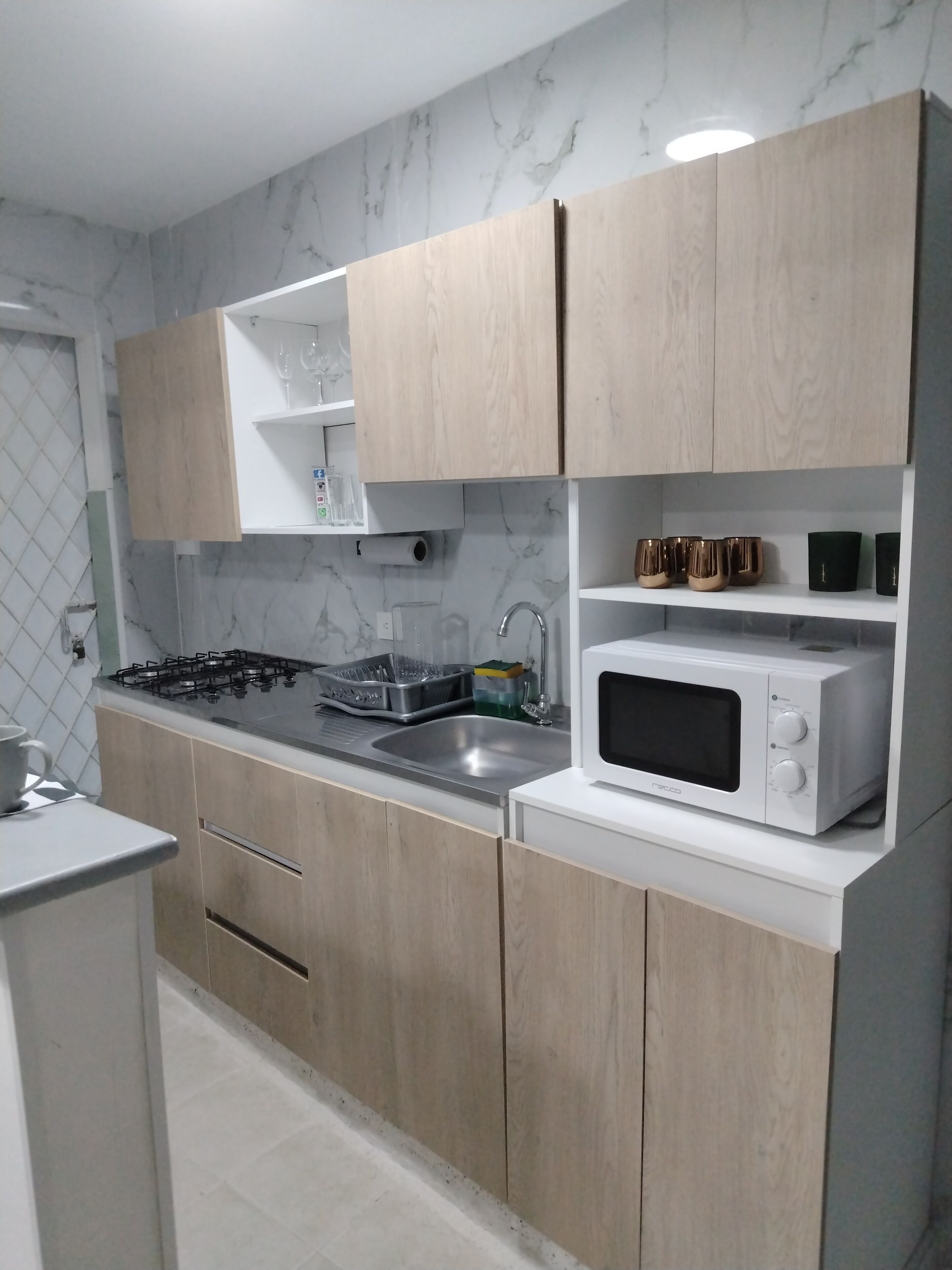 Fridge, microwave, coffee/tea maker, cookware/dishes/utensils