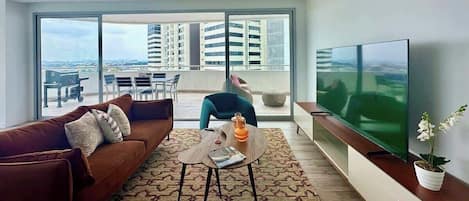 A modern living room with a sofa, coffee table, and TV.