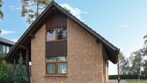 A brick house with a gabled roof and large windows. - Gorgeous home in Röbel with lake view (Röbel)