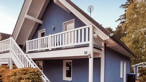 Ein zweistöckiges Haus mit Balkon, Satellitenschüssel und der Hausnummer 96.