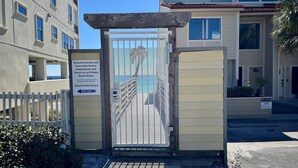 A gated entrance to a building with a sign indicating private beach access. - Beautiful 2 bedroom, 2 bath Destin, Florida Condo! (Destin)