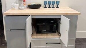 A kitchenette with a microwave, a coffee maker, and a bowl on the countertop. - Cozy 2 bed, 2 bath retreat close to Zion. (Hurricane)