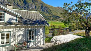 A house with a sloped roof and a view of a valley.