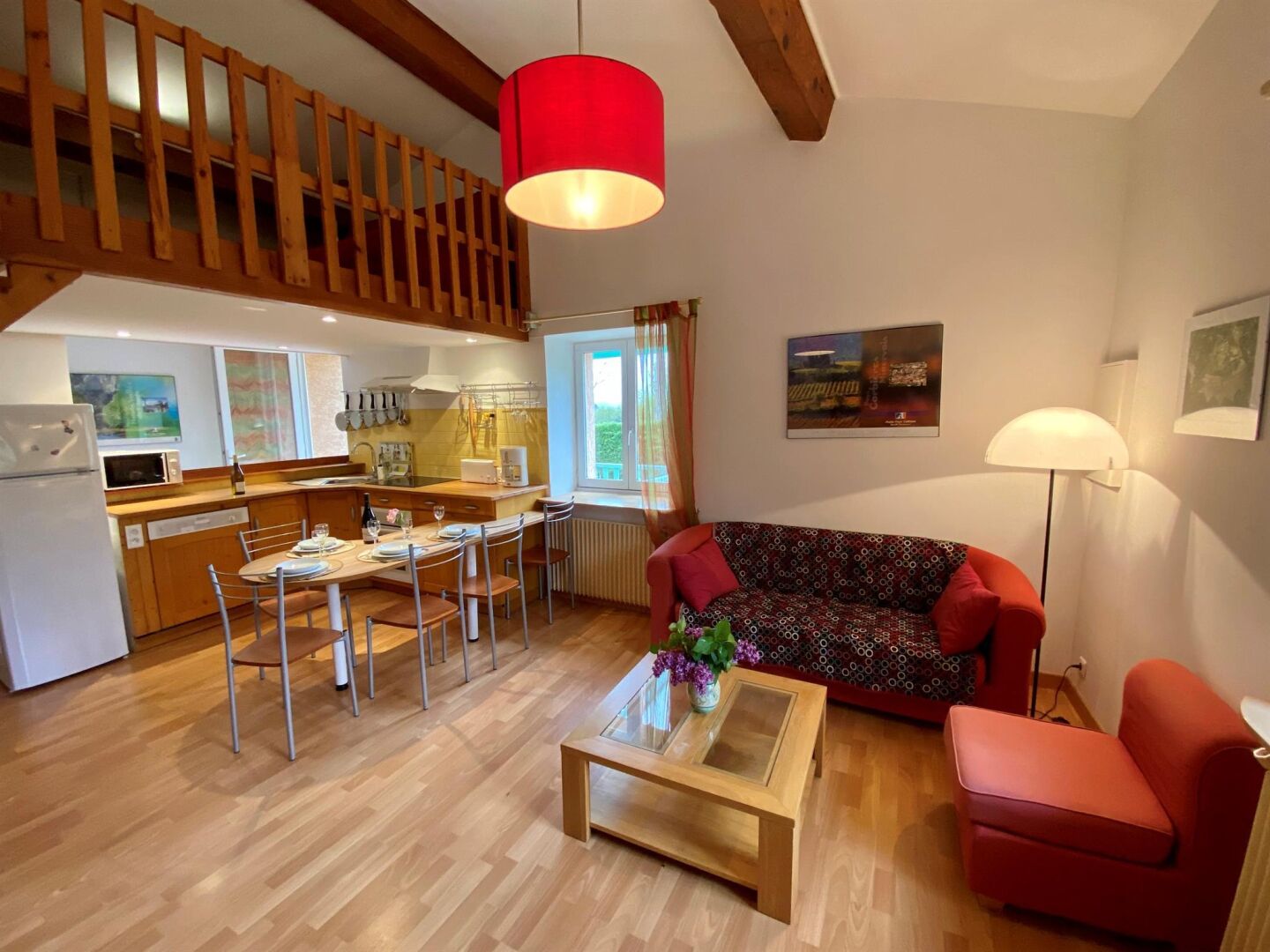 A compact living space with a dining area, kitchenette, and seating area.