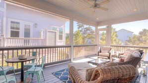 A covered porch with wicker furniture, a table, and chairs. - 2 Homes, Sleeps 25 Pool, Firepit, Free Golf Carts Blue Mountain Beach (Santa Rosa Beach)
