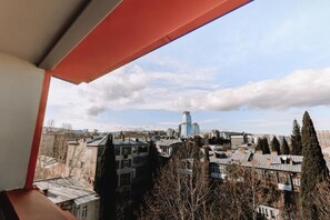 A view from a balcony overlooking a cityscape with buildings and trees. - Hotel Twenties Tbilisi - Stay & Dine (Tbilisi)