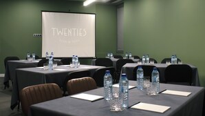 A conference room with tables set up for a meeting, equipped with water bottles and nameplates. - Hotel Twenties Tbilisi - Stay & Dine (Tbilisi)