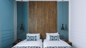 A double bed with a geometric patterned bedspread, a wooden headboard, and two bedside tables with lamps. - Hotel Twenties Tbilisi - Stay & Dine (Tbilisi)