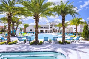 A swimming pool with lounge chairs and palm trees, surrounded by buildings. - Upstay Wonderful Resort Home w Patio & Pool Sleeps 26 (Kissimmee)