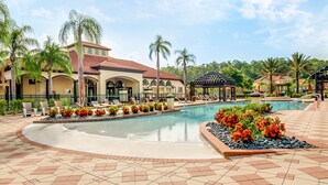 A resort pool area with a tiled deck, lounge chairs, and a gazebo. - Family Resort Homegame Room, Cinema & Theme Rooms (Kissimmee)